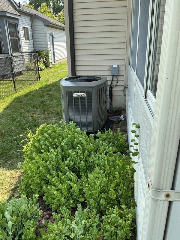 Completed installation of 2.5-ton Lennox air conditioning system with matching evaporator coil in residential property. Outdoor condensing unit positioned on concrete pad in rear yard with proper clearances maintained; indoor air handler and coil installed in basement utility area with new refrigerant lines, condensate drain piping, and electrical connections. System tested and verified operational with all components functioning to manufacturer specifications.