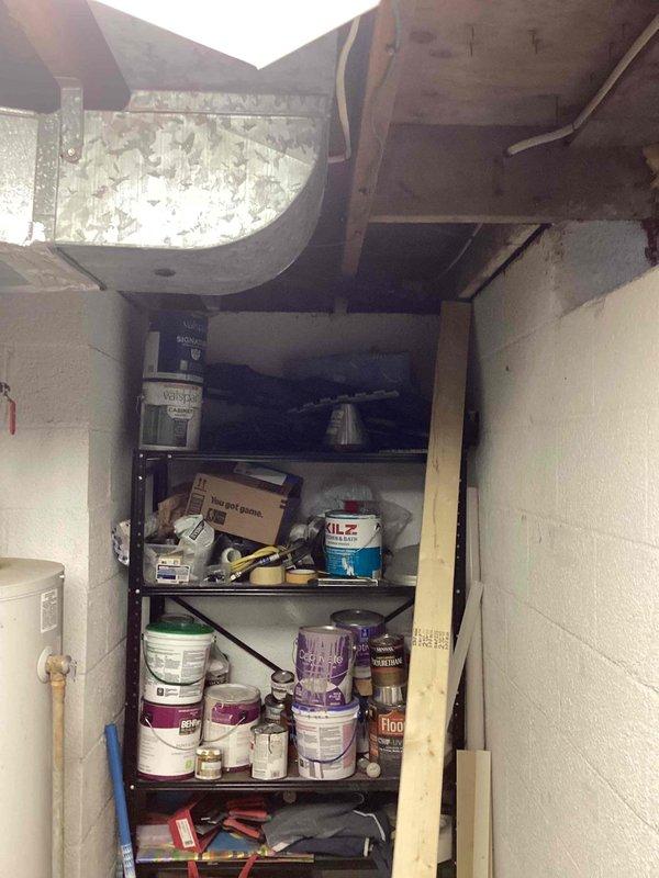 Conducted comprehensive evaluation of aging residential A/C system for replacement estimate. System is approximately 40 years old, significantly beyond its expected service life, though currently operational. Assessed existing ductwork infrastructure in basement utility area, noting galvanized metal construction with visible weathering, accumulated dust, and deterioration. Documented condition of ventilation components including curved ductwork sections showing extensive paint degradation and surface deterioration. Evaluated installation environment and accessibility for future equipment replacement, photographed existing system configuration and surrounding mechanical space to support equipment sizing and installation planning recommendations.