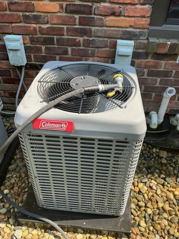 Completed comprehensive Gold AC inspection on 2017 Coleman air conditioning system with condensing unit located exterior and air handler in basement. System confirmed operational with all components functioning properly. Advised customer to maintain clear area around condenser unit, removing any debris and animal waste to ensure optimal airflow and system performance.