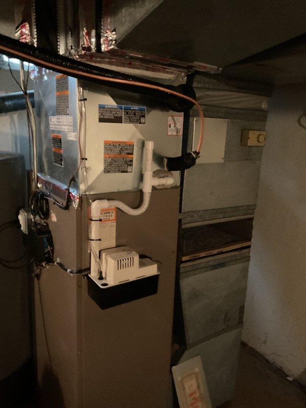 Completed full HVAC system installation including 3-ton air conditioning condenser unit positioned in rear yard on concrete pad with gravel base, and matching evaporator coil installed on furnace in basement utility area. Installed new copper refrigerant lines, PVC condensate drainage with pump, electrical disconnect, and reconnected all mechanical and electrical connections per code requirements. Secured all necessary mechanical, electrical, and HVAC permits prior to installation, installed Sensi thermostat, and registered system for applicable utility rebates with Consumers Energy and DTE.