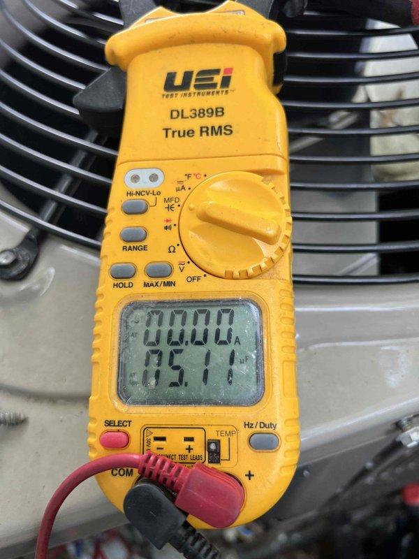 Responded to cooling complaint on 11-year-old basement air conditioning unit. Upon arrival, confirmed system was running but failing to adequately cool the space. Performed diagnostic testing using digital multimeter to measure electrical values and system performance parameters. Readings indicated abnormal operating conditions affecting cooling capacity. Documented system measurements and captured photographic evidence of diagnostic process for service records.