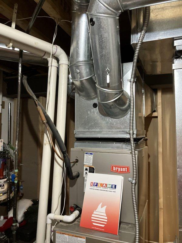 Provided estimate for replacement of 20+ year old Bryant natural gas furnace currently located in basement. Existing unit is operational but nearing end of service life. Assessed current installation including ductwork configuration, PVC venting system, and electrical connections to determine replacement specifications and requirements.