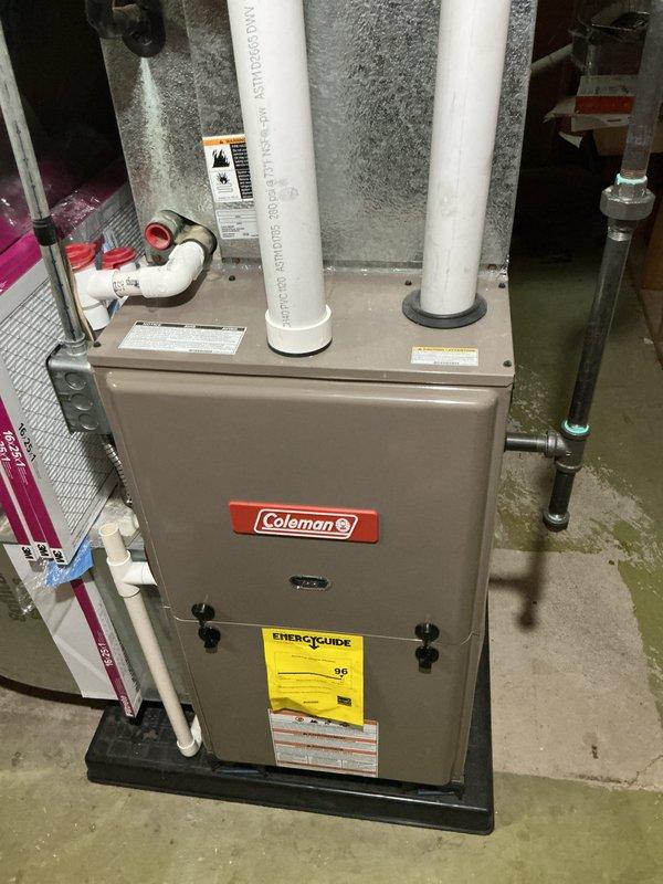 Provided estimate for complete HVAC system replacement in basement installation, including non-functional air conditioning unit and 10+ year old Coleman natural gas furnace. Assessment included documentation of existing equipment configuration with PVC venting system, ductwork with visible condensation issues, and air handler components to determine appropriate replacement specifications for residential comfort system upgrade.