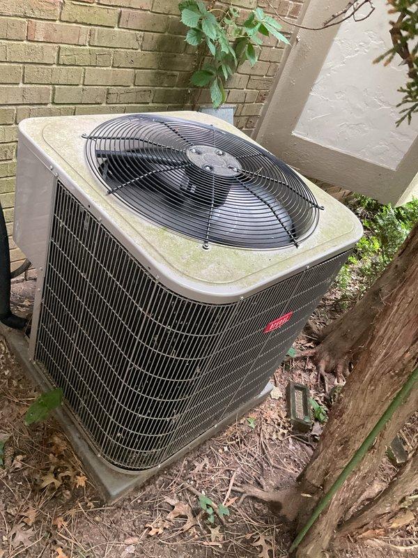 Completed comprehensive Gold AC Inspection on residential air conditioning system with outdoor condenser unit positioned against exterior brick wall. Performed full system diagnostic including refrigerant level check, electrical component testing, condenser coil inspection, and airflow verification. Inspected air filter showing moderate dust accumulation and debris buildup in pleated material. Cleaned condenser unit exterior which exhibited typical outdoor exposure with accumulated leaves, twigs, and organic debris around base and cooling fins. Verified proper operation of condenser fan motor and compressor. Tested thermostat functionality and system cycling. All components operating within manufacturer specifications with no immediate service needs identified. Unit showing normal wear for age with adequate cooling performance maintained.
