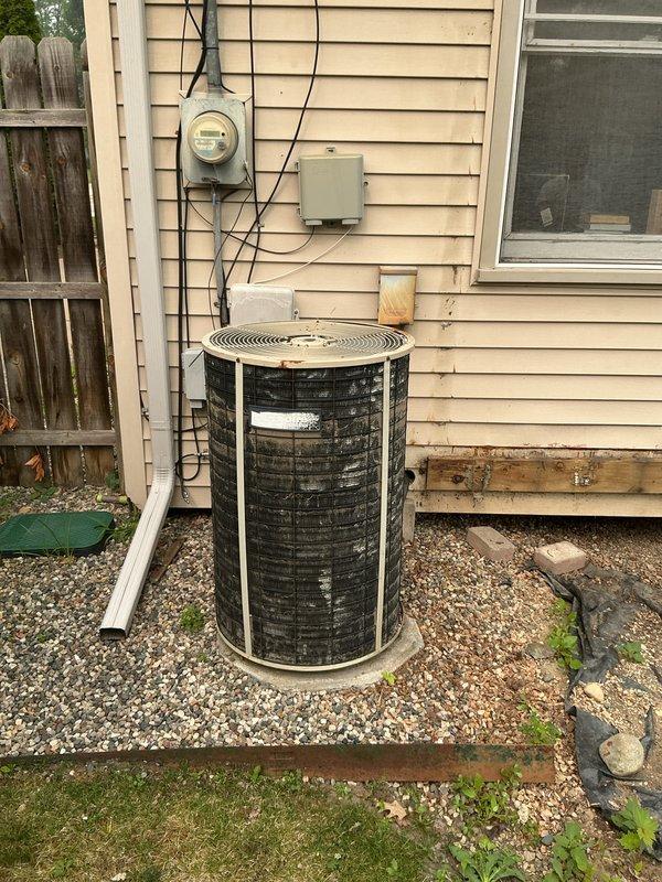 Provided comprehensive estimate for complete HVAC system replacement including outdoor air conditioning condenser unit and basement-located natural gas furnace. Current equipment is 30+ years old and has exceeded its expected service life, making replacement the most cost-effective long-term solution. Assessed existing installation including electrical service, condensate drainage, refrigerant line sets, ductwork connections, and outdoor unit positioning on gravel pad adjacent to home exterior.