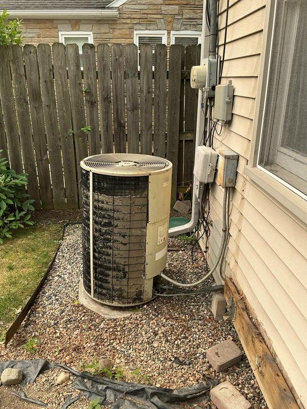 Provided comprehensive estimate for complete HVAC system replacement including outdoor air conditioning condenser unit and basement-located natural gas furnace. Current equipment is 30+ years old and has exceeded its expected service life, making replacement the most cost-effective long-term solution. Assessed existing installation including electrical service, condensate drainage, refrigerant line sets, ductwork connections, and outdoor unit positioning on gravel pad adjacent to home exterior.