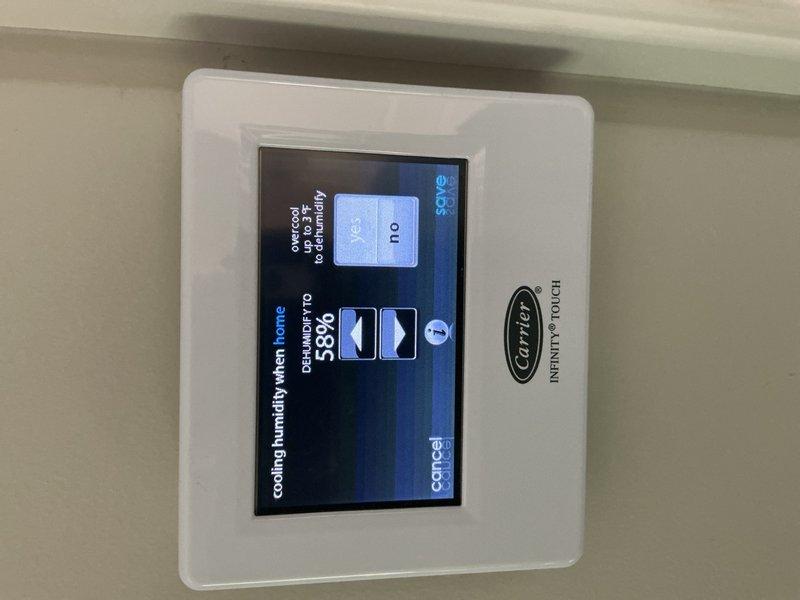 Responded to service call for Carrier system not maintaining desired temperature setpoint. Inspected Carrier Infinity Touch thermostat and verified system settings, including dehumidification and cooling parameters. Confirmed thermostat display functioning properly with humidity reading at 58% and temperature controls operational. Adjusted high and maximum cooling thresholds as needed to restore proper system performance.