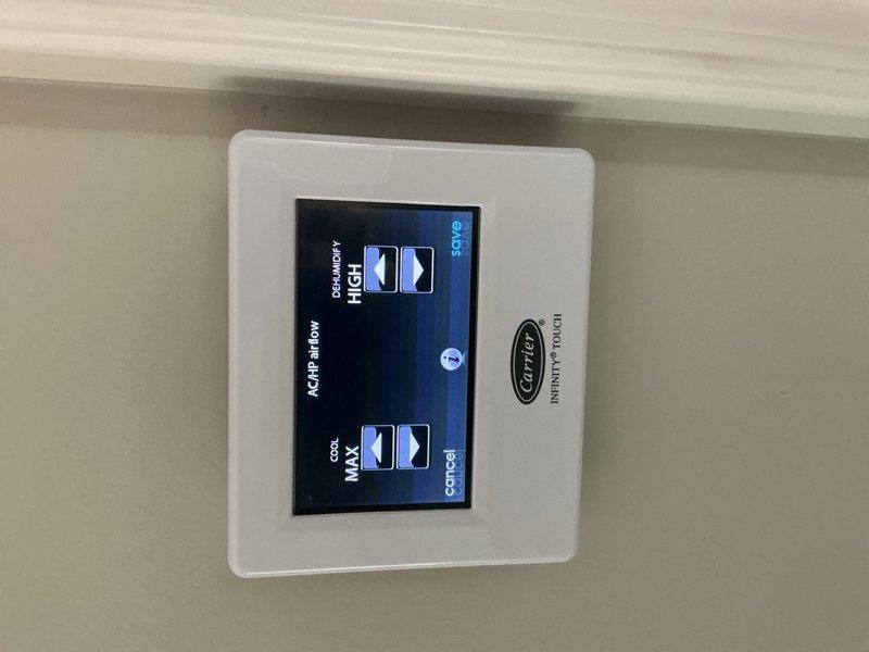 Responded to service call for Carrier system not maintaining desired temperature setpoint. Inspected Carrier Infinity Touch thermostat and verified system settings, including dehumidification and cooling parameters. Confirmed thermostat display functioning properly with humidity reading at 58% and temperature controls operational. Adjusted high and maximum cooling thresholds as needed to restore proper system performance.