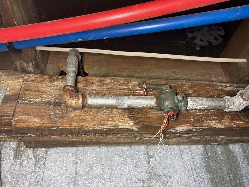 Provided comprehensive plumbing estimate to address code violations identified during property inspection. Assessment included evaluation of water heater installation, supply line connections, drainage piping, and associated plumbing fixtures in basement utility area. Inspection revealed non-compliant installations requiring correction to meet current plumbing codes, including improper pipe support, inadequate venting configurations, and outdated valve assemblies showing significant corrosion and oxidation. Documented existing conditions of flexible braided supply lines with color-coded hot and cold water connections, metallic drainage elbows, and PEX tubing distribution system. Quote encompasses necessary modifications to bring all plumbing components into compliance with municipal building codes and ensure proper functionality of water heater connections and drainage systems.