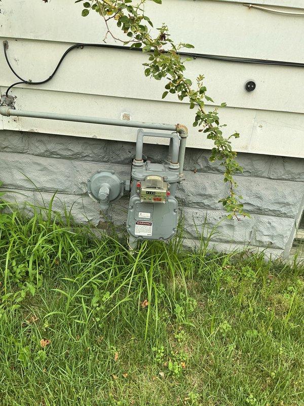 Conducted site assessment for Kohler generator installation estimate at residential property. Evaluated existing natural gas meter location and capacity on exterior foundation wall, documented gas line routing through basement utility space, and verified clearances and accessibility for generator placement. Assessed electrical infrastructure and determined optimal equipment positioning based on existing utility connections and building configuration.