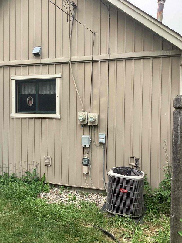 Completed electrical estimate for new whole home generator installation at residential property. Assessed existing electrical infrastructure including dual meter configuration and main electrical panel location for integration with proposed generator system. Documented current electrical service setup, meter placement on exterior wall, and interior panel box with circuit breaker arrangement to determine load requirements and transfer switch positioning for seamless automatic backup power integration.