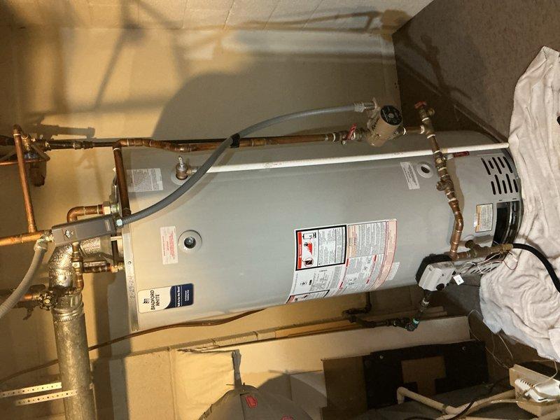 Replaced a non-functioning 75-gallon Bradford White water heater under warranty with a new 75-gallon Bradford White unit. Connected copper supply lines, pressure relief valve, and all necessary plumbing connections to restore hot water service. Expansion tank installation to be scheduled for follow-up visit.