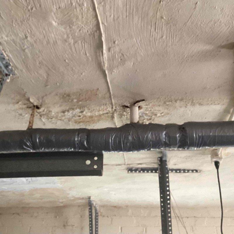 Responded to service call for leaking boiler pipes in basement on 10+ year old system. Upon inspection, identified active corrosion and rust deterioration at pipe coupling connections on vertical supply lines, with visible moisture damage and staining on surrounding ceiling areas. Documented existing conditions including compromised pipe insulation, corroded metal fittings, and aging infrastructure requiring immediate attention to prevent further water damage and system failure.