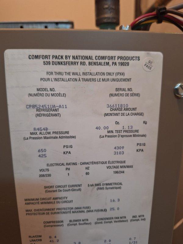 Successfully installed a National Comfort Products heat pump with cooling system, Model CPBE34511IA-A11, utilizing R-454B refrigerant. The installation included proper electrical connections at 208/230V single-phase, with circuit protection rated at 25.0A maximum overcurrent and 14.3A minimum circuit ampacity. Exterior penetrations were completed through the brick facade with appropriate ventilation louvers installed, and three white PVC condensate drain lines were routed vertically along the building exterior for proper drainage management.