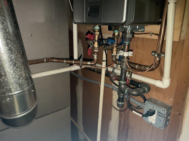 Performed routine maintenance flush on tankless water heater system to remove mineral buildup and sediment accumulation. Isolated unit using existing service valves, connected flushing equipment with descaling solution, and circulated cleaning agent through heat exchanger for optimal performance. Inspected all copper supply lines, valve assemblies, and connections for proper operation; verified system restored to normal function with no leaks detected upon completion.