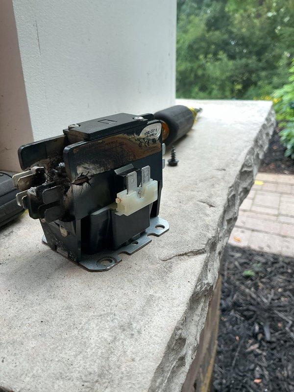 Responded to callback for AC condenser not starting after run capacitor replacement two days prior. Upon inspection, found contactor severely corroded with rust on terminals and contact points, preventing proper electrical connection. Removed and replaced failed contactor, verified all wire connections secure, and tested system operation. Unit now cycling properly with condenser engaging as designed.