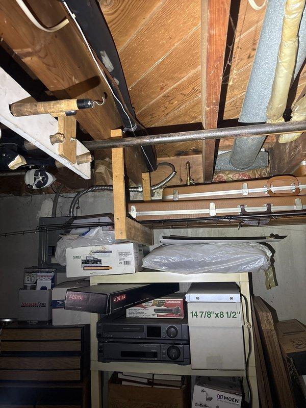 Completed comprehensive electrical inspection of residential basement electrical panel and associated wiring systems. Evaluated panel condition, circuit loading, wire routing through floor joists, and proper securing of conductors with appropriate fasteners. Assessed conduit connections, grounding systems, and overall code compliance of the electrical installation in the unfinished basement utility area.