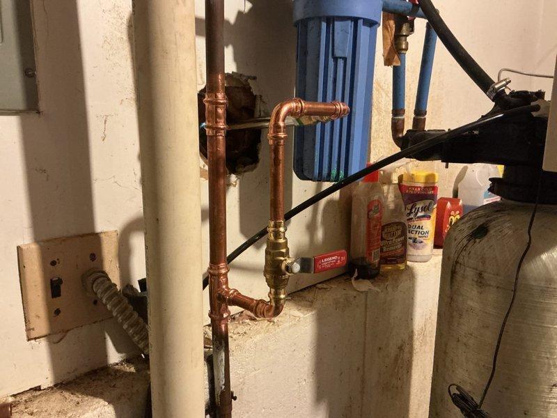 Replaced frost-free outdoor hose spigot mounted on exterior siding. Installed new fixture with proper copper pipe connections and brass valve assembly in basement utility area, ensuring secure mounting and leak-free operation for seasonal water access.