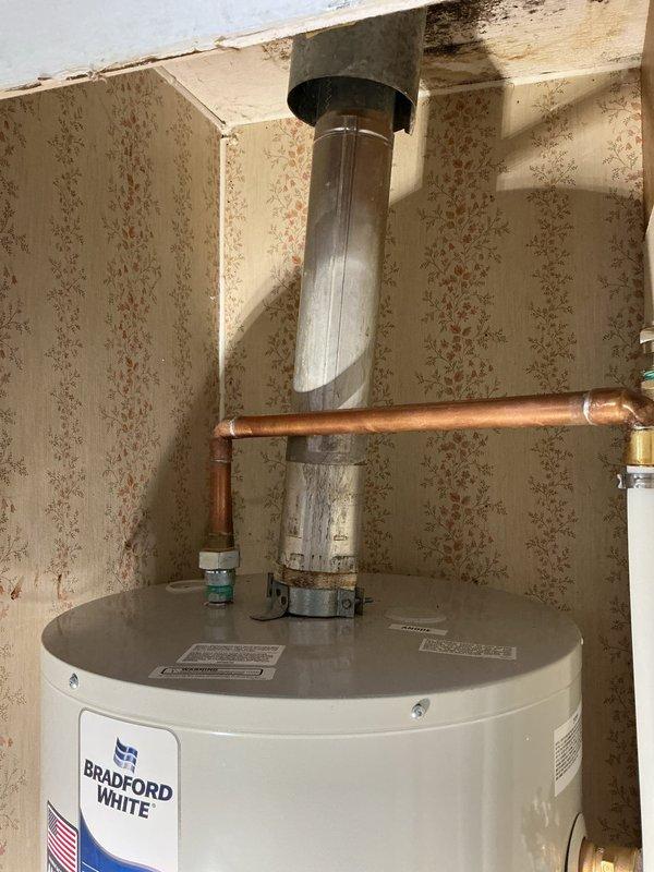 Completed warranty inspection on Bradford White residential water heater installation. Identified code violation where PEX piping was improperly used for temperature and pressure relief valve discharge line, which requires metallic piping per plumbing standards. Documented incomplete installation requiring necessary corrections including proper T&P relief valve piping, water heater platform or stand installation per code requirements, and wall access closure. Unable to perform complete inspection due to ongoing construction conditions with exposed wall framing and unfinished surfaces around installation area. Provided callback instructions for final inspection upon completion of required repairs and proper access restoration.