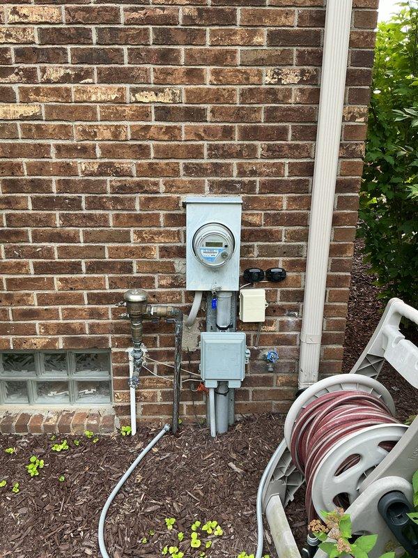 Provided estimate for replacement of 10+ year old air conditioning unit and natural gas furnace located in basement. Current furnace operational but air conditioning unit not functioning. Documented existing equipment installation and exterior utility connections for replacement specifications.