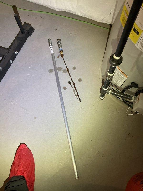Replaced deteriorated anode rod in water heater to prevent tank corrosion and extend equipment lifespan. The existing rod showed significant corrosion and mineral buildup, indicating it had reached the end of its effective service life. Installed new anode rod and verified proper fitting to ensure continued protection of the water heater tank.