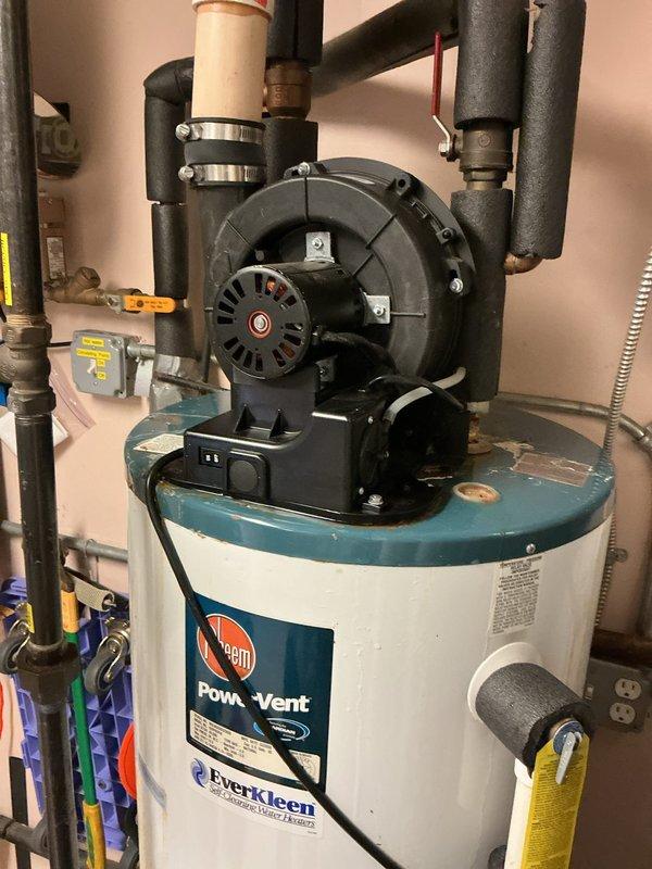 Responded to service call for 50-gallon Rheem PowerVent water heater experiencing intermittent flame failure, with unit shutting down approximately every three days. Performed diagnostic inspection of the power vent system, including examination of the blower motor assembly, gas valve operation, and ignition components. Assessed venting system integrity, verified proper combustion air supply, and inspected flame sensor and thermocouple functionality to identify root cause of pilot light extinguishing issue.