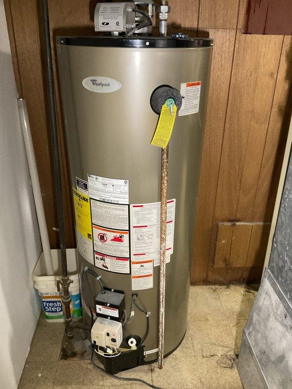 Responded to service call for Whirlpool tanked water heater experiencing extended heating times. Upon inspection, found unit to be over 10 years old with sediment buildup affecting heating efficiency. Assessed gas burner assembly, thermostat controls, and temperature-pressure relief valve functionality. Inspected flue vent penetration and verified proper venting with adequate sealing at wall penetration point. Evaluated overall condition of unit including plumbing connections, gas line integrity, and safety controls. Documented equipment age and performance issues, noting unit approaching end of serviceable life expectancy. Provided homeowner with findings and recommendations for addressing slow heating performance.