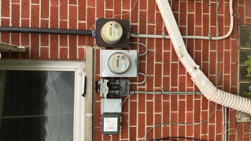 Responded to a return service call for a 3-year-old AC system located in the basement that remained non-operational following a previous visit. Upon arrival, performed visual inspection of the electrical service and metering equipment, documenting the DTE meter configuration and exterior electrical panel condition. Verified power supply to the unit and assessed the electrical infrastructure supporting the HVAC system to rule out upstream power delivery issues as the cause of the no-cool condition.