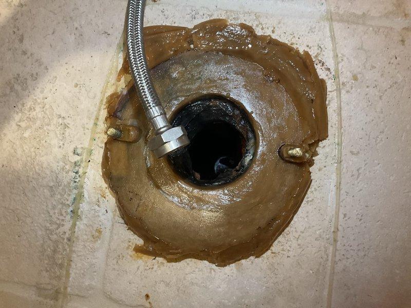 Responded to service call for bathroom plumbing assessment. Upon inspection, identified floor drain with visible staining and residue accumulation around the fixture, indicating potential drainage issues or backup concerns. Evaluated the drain assembly, including the metal mounting flange and connected braided stainless steel supply line with chrome coupling. Assessed overall bathroom plumbing system functionality, including toilet operation and fixture condition. Provided comprehensive quote for necessary repairs to address drainage concerns and restore proper function to the floor drain system. Customer accepted proposed repair solution.
