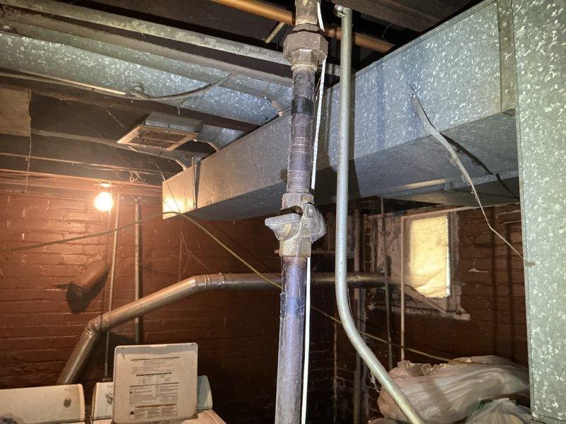 Responded to gas leak in basement affecting specific area. Located leak in dark metal gas line pipe running vertically through utility space near exposed ceiling beams and support column. Performed pressure test to isolate compromised section of gas piping. Leak had been present for approximately one week prior to service call. Repaired affected gas line section using appropriate fittings and connections, ensuring all joints were properly sealed and secured. Conducted post-repair pressure test to verify system integrity and confirm no additional leaks present. Restored gas service to affected area safely.