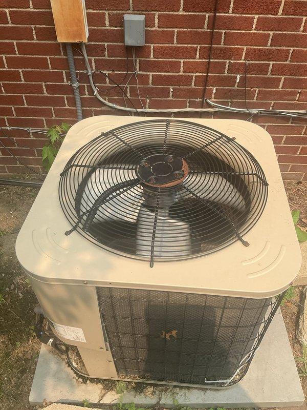 Responded to service call for furnace displaying red indicator light and air conditioning system operating only on first floor. Inspected one-year-old furnace unit located in basement and outdoor condensing unit of unknown age. Performed diagnostic evaluation of both HVAC systems to identify fault conditions causing limited cooling distribution and furnace error status. Documented equipment conditions with photographs showing outdoor condenser unit on concrete pad against exterior brick wall and basement furnace installation area. Addressed system malfunctions to restore proper heating and cooling operation throughout residence.