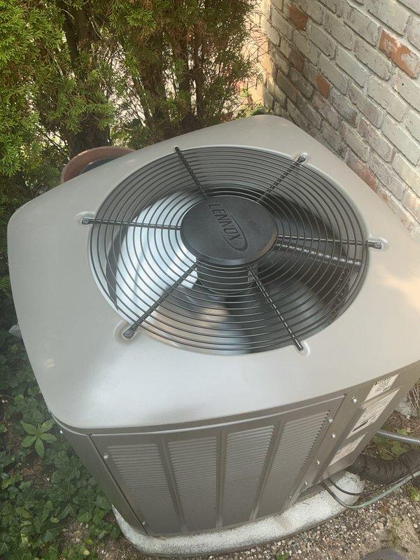 Completed comprehensive Gold AC inspection on Lennox condensing unit positioned on exterior concrete pad with air handler located in basement. System is under 10 years old and operating properly at time of inspection. Verified proper operation of condenser fan motor, checked refrigerant pressures, inspected electrical connections, and evaluated overall system performance. Advised customer to maintain clear area around outdoor unit, removing any debris and animal waste to ensure adequate airflow and prevent potential system issues.
