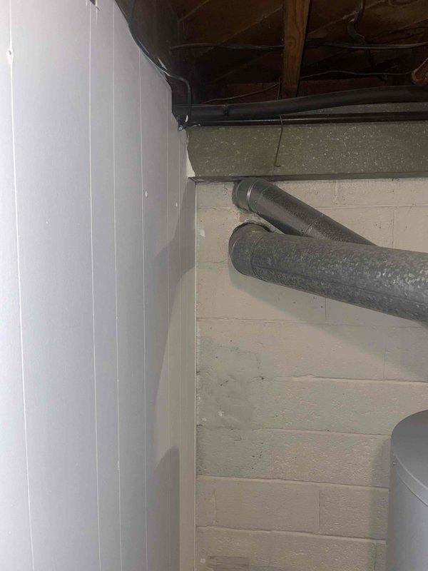 Conducted on-site evaluation for furnace replacement in residential basement. Assessed existing Rheem furnace unit, approximately 50 years old, with pale yellow cabinet showing surface discoloration and wear consistent with age. Documented current system configuration including metal supply ductwork, flexible return ducts, and existing venting arrangement. Evaluated mechanical room layout with water heater proximity and available clearances for new equipment installation. Provided comprehensive replacement quote for modern high-efficiency furnace system to replace aging unit that has exceeded its typical service life expectancy.