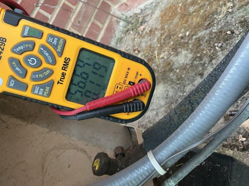 Completed comprehensive Gold AC Inspection on 15-year-old outdoor air conditioning unit located in backyard. Performed full system diagnostics including electrical measurements with digital multimeter, recording voltage and amperage readings to verify proper compressor and condenser operation. Inspected refrigerant lines, connections, and insulation integrity; checked condensate drain line for proper flow; cleaned condenser coils; and evaluated overall system performance. All components found operating within manufacturer specifications with no deficiencies noted. System running efficiently with no immediate service needs identified.