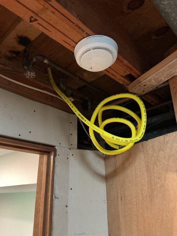 Responded to homeowner report of gas leak in residential property. Upon arrival, conducted comprehensive visual inspection of gas piping system in mechanical room, identifying aging galvanized steel pipes with visible surface corrosion and multiple connection points requiring evaluation. Performed systematic pressure test on gas distribution lines to isolate and verify leak location. Inspected copper and galvanized pipe connections, fittings, and shut-off valves throughout the system, paying particular attention to corroded joints and T-fittings showing signs of deterioration. Tested all accessible gas line connections in utility area and adjacent spaces, including areas near water heater installation. System pressure test confirmed integrity of gas lines; no active leaks detected at time of inspection. Verified proper operation of existing shut-off valves. Advised homeowner that while no immediate leak was found during testing, the visible corrosion on aging galvanized pipes warrants 