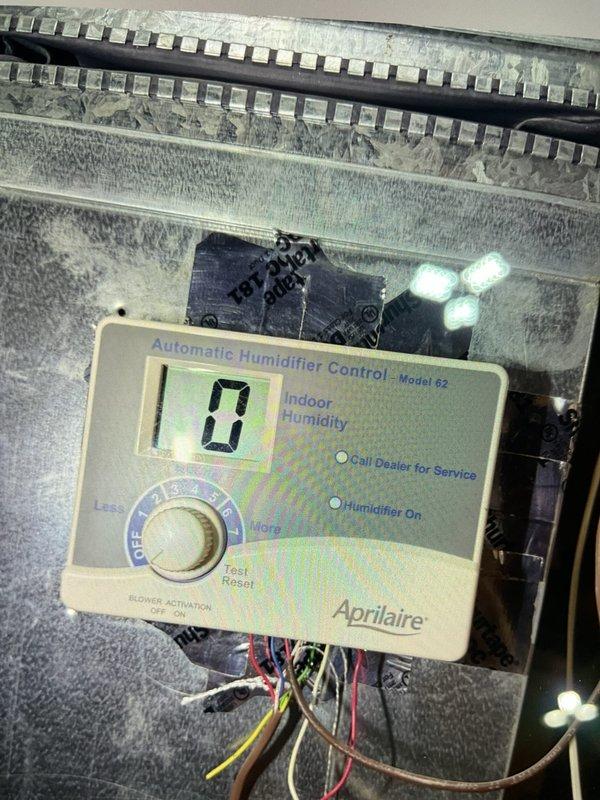 # HVAC Maintenance - Gold AC Inspection

Completed comprehensive spring tune-up and inspection on dual 5-year-old air conditioning system consisting of outdoor compressor units and basement-located air handler. Performed standard preventive maintenance protocol including inspection of electrical connections, refrigerant levels, condensate drainage, air filters, and overall system operation. Verified proper cycling of both units with no deficiencies noted.

Inspected auxiliary equipment in mechanical room including Bradford White 40-gallon natural gas water heater (installed September 2015) and Aprilaire Model 62 automatic humidifier control mounted on HVAC ductwork. Noted humidifier control displaying zero humidity reading with indicator lights functional. Observed dust accumulation on ductwork surfaces typical for seasonal operation.

All systems tested and confirmed operational with no immediate service needs identified. Equipment functioning within normal parameters for age and usag