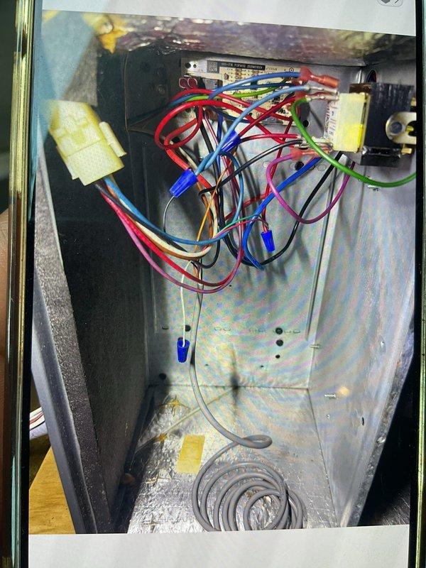 Responded to no cooling call on 5-year-old system located in attic above garage. Found blower motor operating but compressor and condenser unit not running. Safety float switch in drain pan had tripped to red position due to condensate backup; reset switch to green position and verified proper drainage. Inspected electrical connections at air handler, checked wiring terminations and control board for proper voltage and continuity. System remained non-operational after float switch reset, indicating potential issue with compressor contactor, capacitor, or low voltage control circuit requiring further diagnostic testing and component replacement.