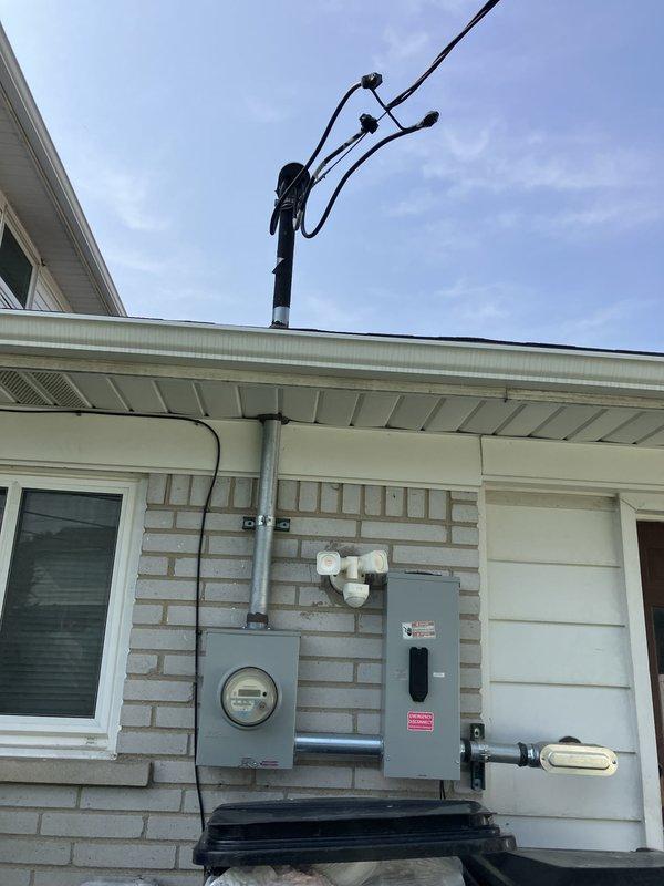 Conducted on-site assessment for complete air conditioning system replacement at residential property. Evaluated existing electrical infrastructure including meter location and panel box positioning on exterior brick wall, and assessed interior ceiling access point for potential ductwork modifications and equipment installation routing. Documented current site conditions to develop comprehensive replacement specifications for new AC unit installation.