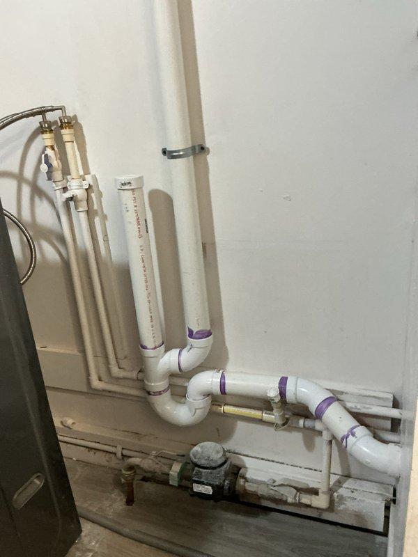 Responded to newly purchased home for comprehensive plumbing assessment focusing on garbage disposal malfunction, gurgling drains, and multiple sink leakage issues reported over 30-day period. Conducted thorough inspection of kitchen and bathroom plumbing systems, including drainage lines, water supply connections, and waste disposal unit. Examined main plumbing infrastructure including PVC drainage system, water filtration components, and mechanical equipment installations. Identified and documented condition of residential plumbing configuration including vertical and horizontal pipe runs, connection points, supply valves, and treatment devices. Assessed garbage disposal unit operation, drain venting adequacy, and potential cross-connection issues contributing to gurgling sounds in multiple fixture locations. Photographed plumbing installations and confined mechanical access areas for documentation purposes. Provided homeowner with findings regarding overall system condition and reco
