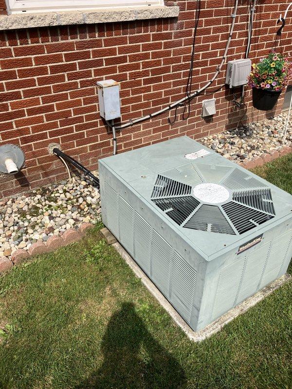 Conducted comprehensive assessment of existing 10+ year old HVAC system including natural gas furnace located in basement and air conditioning condenser unit positioned on exterior concrete pad with white gravel landscaping. Evaluated current equipment operational status, documented existing installation configuration including electrical connections, conduit routing, and utility box placement on brick exterior wall. Provided detailed replacement estimate for complete furnace and air conditioning system upgrade to improve efficiency and reliability of residential heating and cooling equipment.