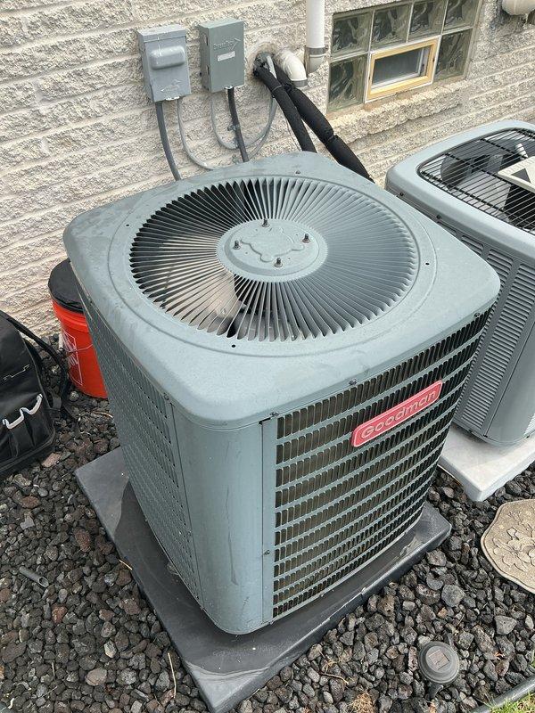Completed comprehensive Gold AC Inspection and tune-up on two Goodman air conditioning condenser units located on exterior of building. Both systems were operational at time of service. Performed full preventive maintenance protocol including visual inspection of condensing units, verified proper refrigerant line insulation, checked electrical connections and conduit routing, inspected mounting pads and surrounding gravel base for levelness and stability, examined fan blade operation and protective grilles, and documented equipment condition through photographic records. Both units showed normal wear consistent with routine operation, with no immediate repairs required at this time.