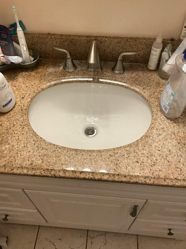 Completed comprehensive 16-point plumbing inspection of residential property. Inspection revealed active water pooling around HVAC/furnace unit in basement area, with visible moisture accumulation on concrete floor requiring further investigation of potential leak sources from nearby PVC piping or condensate drainage system. Evaluated bathroom plumbing fixtures including undermount sink with widespread faucet assembly, verified proper drainage function, and assessed overall condition of visible supply lines and waste connections throughout accessible areas of the home.