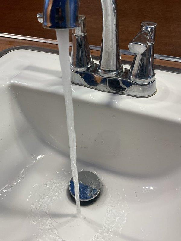 Responded to a clogged main floor bathroom sink that had been stopped up for approximately one week in a 50-year-old home. Upon arrival, respected homeowner's request for shoe covers before entering the residence. Assessed the affected fixture and determined the blockage was isolated to this sink only, with no drainage issues reported at other plumbing fixtures throughout the home.

Performed diagnostic evaluation of the bathroom sink drain system to identify the source and location of the obstruction. Removed the pop-up drain stopper assembly to access the drain opening and inspect for visible debris or buildup. Utilized appropriate drain cleaning tools to clear the blockage from the drain line, working through the P-trap and branch drain as needed to restore proper water flow.

Cleared accumulated hair, soap residue, and organic matter that had built up over time in the drain assembly and trap, which is common in bathroom sinks of this age. Ensured complete removal of all obstructing