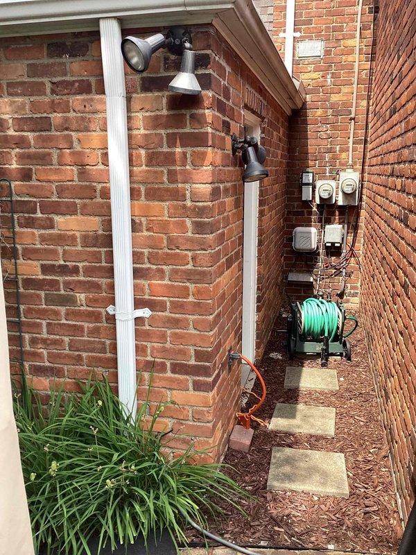 Completed electrical estimate for new whole home generator installation at residential property. Evaluated side yard access corridor between brick structures, assessed utility meter locations and existing electrical infrastructure, and reviewed property survey to determine optimal generator placement while maintaining required setback clearances from property lines and structure. Documented site conditions including narrow passage constraints, existing utilities, and available space for equipment installation and service access.