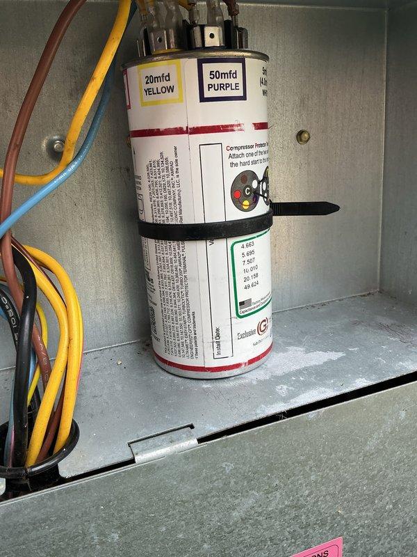 Completed comprehensive Gold AC Inspection on outdoor residential condensing unit. Performed full system diagnostics including electrical component inspection, verified dual-run capacitor terminals (20mfd and 50mfd ratings) with proper color-coded wiring connections intact, checked all electrical connections at control panel, and inspected exterior cabinet condition. Unit showed normal wear consistent with age, operating within manufacturer specifications with no immediate service needs identified.
