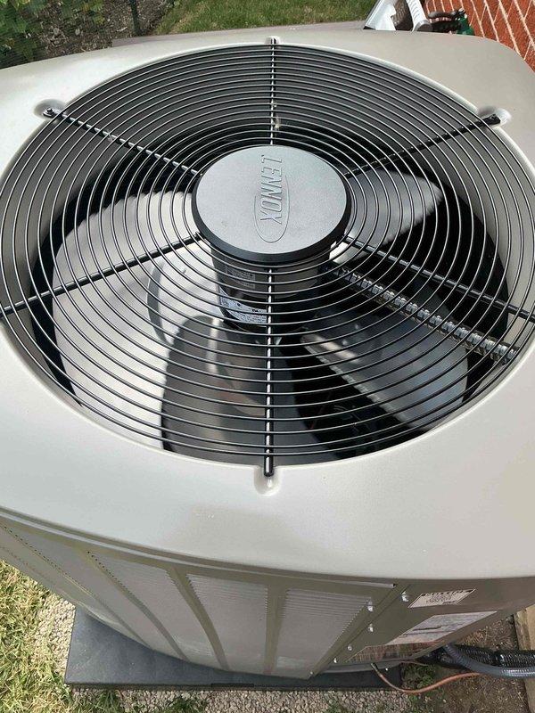 Responded to warranty callback for newly installed complete HVAC system experiencing freeze-up conditions immediately after initial installation. System consists of Lennox EL18KCV-036-230B04 3-ton air conditioning unit (manufactured 06/2026, serial 5826F10035) and 70,000 BTU furnace with humidifier installed in rear yard location. Inspected outdoor condenser unit, verified proper fan operation, confirmed unit mounted on concrete pad with adequate clearance. Reviewed installation specifications including 208/230V single-phase electrical connection, 7 lbs factory refrigerant charge, and AHRI certification number 216722046. Photographically documented equipment condition showing clean Lennox condenser with intact protective grille and proper exterior mounting. Addressed freezing issue through diagnostic evaluation of airflow, refrigerant levels, and system controls to restore proper operation per manufacturer specifications.
