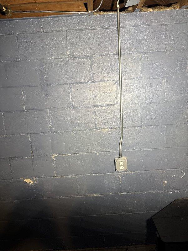 Performed comprehensive electrical maintenance inspection and corrections at residential property. Inspected main and sub panels for corrosion issues, identifying areas requiring attention and cleaning. Addressed electrical safety hazards including outlets with reverse polarity and missing grounding connections, rewiring affected receptacles to meet current electrical code standards. Installed additional duplex outlets in basement and kitchen areas per customer request, running new metallic conduit along cinder block walls and making proper connections to existing circuits. All new and corrected outlets were tested for proper polarity, grounding, and functionality. Documented installation with photographs showing completed conduit runs and properly mounted outlet boxes on basement walls.