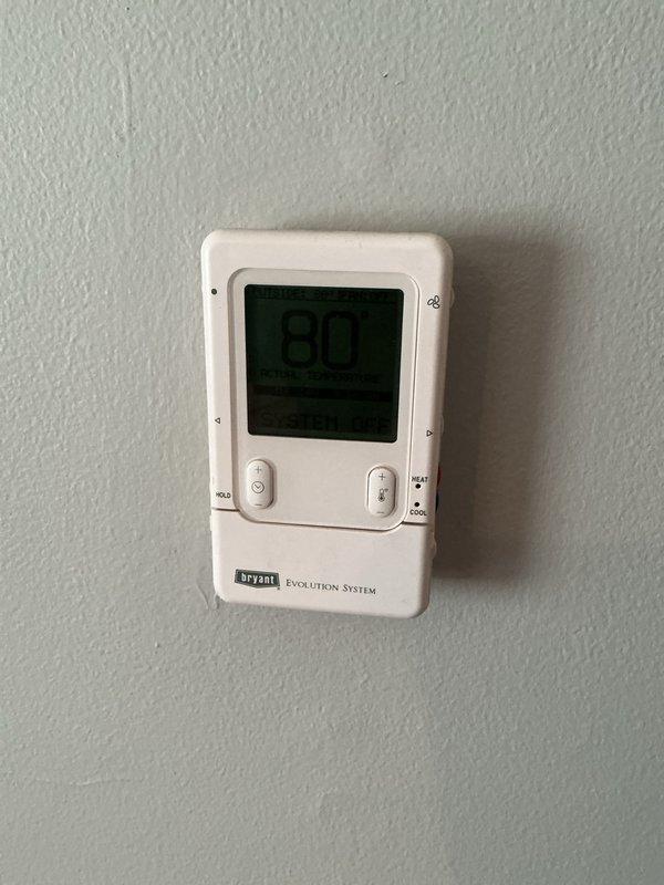 Conducted comprehensive on-site evaluation for complete HVAC system replacement including air conditioning unit and furnace installation. Assessed existing Bryant Evolution System thermostat, inspected current ductwork configuration and mechanical infrastructure in basement area, documented water heater proximity and available installation space. Photographed existing equipment layout, duct runs, and PVC ventilation system to develop accurate replacement specifications and installation requirements for full system upgrade proposal.