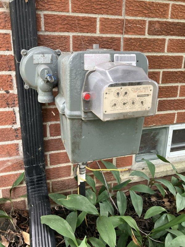 Conducted site assessment for Kohler generator installation estimate at residential property. Documented existing natural gas meter and electrical service configuration, including dual digital utility meters with conduit routing on exterior wall. Evaluated gas supply infrastructure and electrical metering setup to determine specifications and requirements for proposed standby generator system integration.