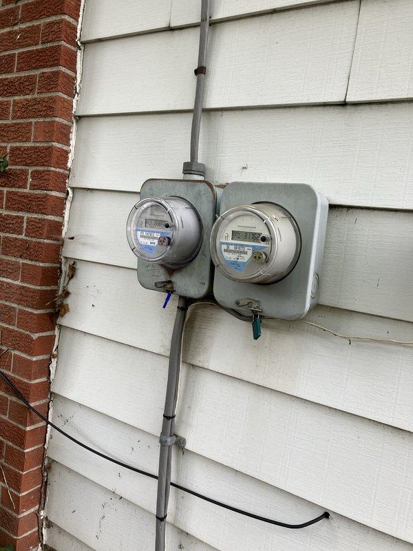 Conducted site assessment for Kohler generator installation estimate at residential property. Documented existing natural gas meter and electrical service configuration, including dual digital utility meters with conduit routing on exterior wall. Evaluated gas supply infrastructure and electrical metering setup to determine specifications and requirements for proposed standby generator system integration.